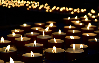 Lit Candles Glittering In Dark